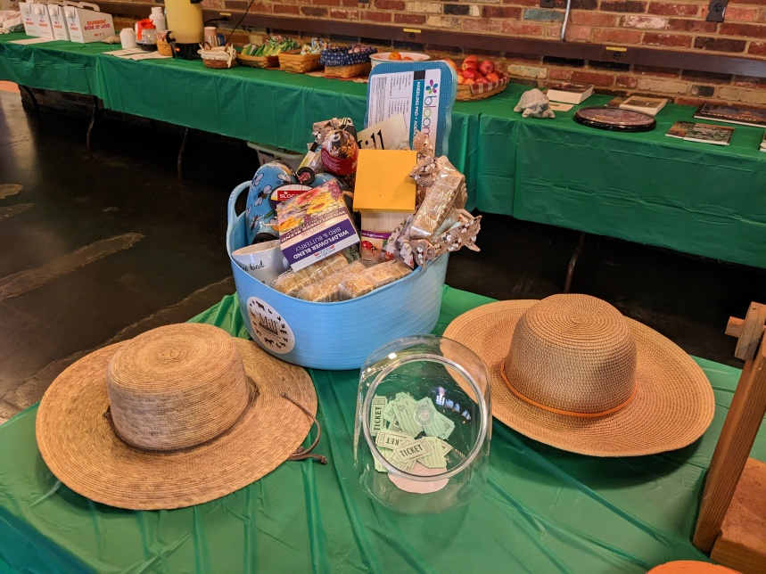 The grand prize included two garden hats. Refreshments (see tables at top right) included coffee, tea, juice, oranges, apples, and breakfast bars. They were laid out in the morning and remained for the day. Lunch consisted of subs, chips, cookies, and water.
